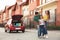 Happy parents hugging their  near family car on street