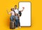 Happy parents with little daughter carrying suitcases, posing over phone