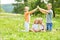 Happy parents shape roof with hands