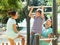 Happy parents with son training on pull-up bar