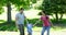 Happy parents swinging their son between them in the park