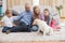 Happy parents and their children on floor with puppy