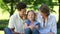 Happy parents with their young daughter in the park