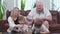 Happy parents and two joyful sons playing in board game, wooden tower