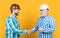 happy partners men handshaking isolated on yellow. partners men handshaking in studio.