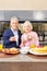 Happy pensioner couple with mug of coffee