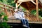 Happy pensioner hugging his wife while sitting on the bridge with her