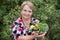 Happy pensioner woman with vegetables at dacha