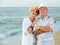 happy pensioners woman and man on the beach