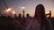 Happy people are dancing with big sparklers. Emotional woman in white shirt in closeup, against background of her