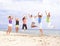 Happy people jumping on the beach