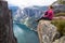 Happy people relax in cliff during trip Norway. hiking route