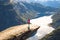 Happy people relax in cliff during trip Norway. Trolltunga hiking route