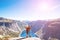 Happy people relax in cliff during trip Norway. Trolltunga hiking route. Toning picture