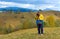 Happy photographer on autumn mountain background