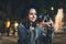Happy photographer tourist girl with retro camera take photo on background bokeh light in evening city, Blogger photoshoot photo