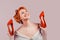 Happy pinup girl holding heeled shoes laughing excited cheering
