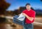 Happy pizza deliveryman with delivery bag in the city at evening