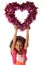 Happy playful child holding heart shape