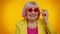 Happy playful elderly granny woman in red sunglasses blinking eye, looking at camera with smile