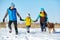 Happy playing family with St. Bernard dog in the winter. people outdoors