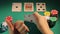 Happy poker player checking cards, showing thumbs-up hand sign, lucky game