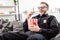 Happy policeman in 3d glasses sitting on couch, eating popcorn and