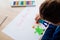 Happy Polish child drawing a greeting card for his grandma.