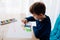 Happy Polish child drawing a greeting card for his grandma.