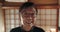 Happy, portrait and senior Japanese man at his home with positive, good and confident attitude. Smile, glasses and face