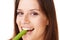 Happy, portrait and woman with celery in a studio for health, wellness and diet snack for lunch. Smile, weight loss and