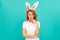 happy positive easter woman in bunny ears and bow tie on blue background