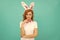 happy positive easter woman in bunny ears and bow tie on blue background