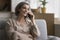 Happy positive mature woman talking on cellphone call