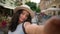 Happy positive smiling teen tourist traveler woman Indian Arabian ethnic female girl student taking selfie photo posing