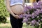 Happy pregnancy women walk in the garden near birches