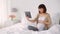 Happy pregnant asian woman with tablet pc at home