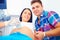 Happy pregnant couple on ultrasound diagnostic