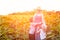 Happy pregnant mother hugging two little sons on sunny field of blooming sunflowers