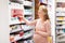 Happy pregnant woman with medication at pharmacy