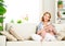 Happy pregnant woman relaxing at home with toy teddy bear