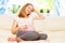 Happy pregnant woman is resting at home on sofa