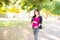 Happy pregnant woman in sportswear walking outdoors