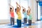 Happy pregnant women exercising on mats in gym