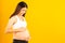 Happy pregnant young asian woman touching belly and admiring her baby or fetus with happiness smile face. Young Asia mother love