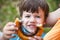 Happy preschool boy offering cocoa snail