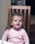 Happy preschool girl in chair