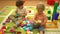Happy preschool kids playing with multi coloured blocks at indoor playground. Education in nursery school