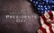 Happy presidents day concept with flag of the United States on dark stone background