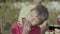 Happy preteen boy enjoying hotdog at barbecue party